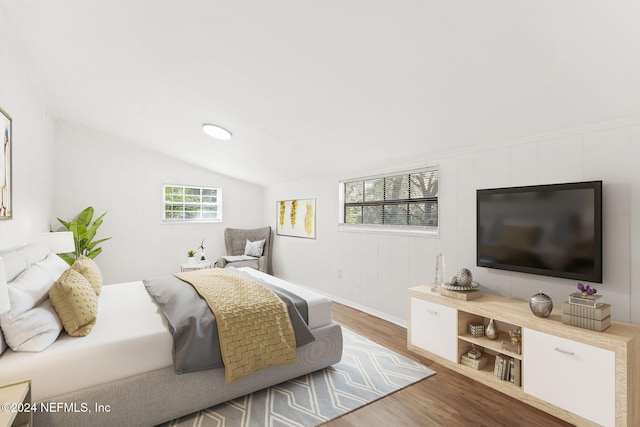 bedroom with hardwood / wood-style floors and vaulted ceiling