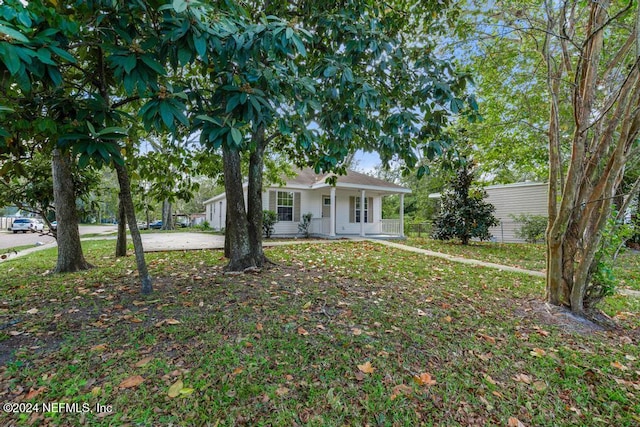 single story home with covered porch and a front lawn