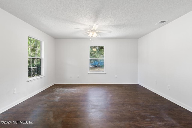 unfurnished room with ceiling fan, a textured ceiling, and dark hardwood / wood-style flooring