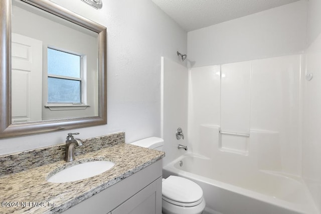 full bathroom with toilet, a textured ceiling, shower / tub combination, and vanity