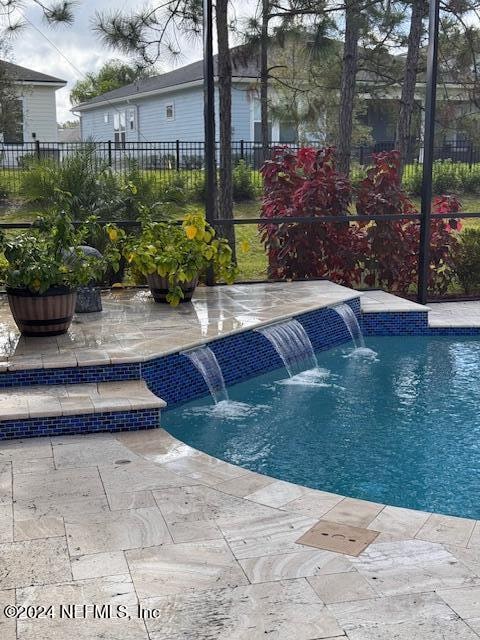 view of swimming pool with a patio area and pool water feature