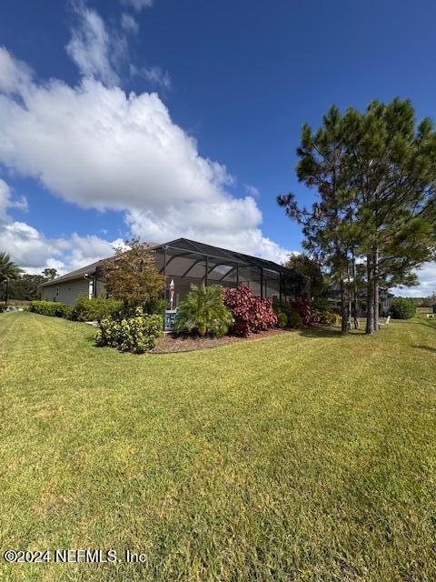 211 Dolcetto Dr, Saint Augustine, FL 32092 - view of grassy yard with a lanai