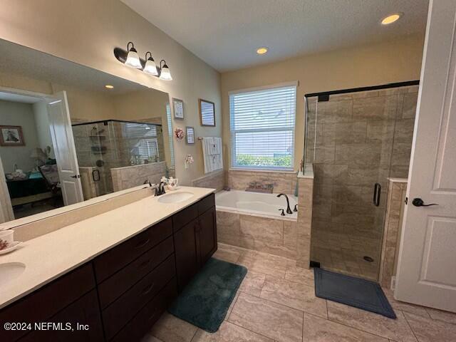 211 Dolcetto Dr, Saint Augustine, FL 32092 - full bathroom with a bath, double vanity, a stall shower, tile patterned flooring, and recessed lighting