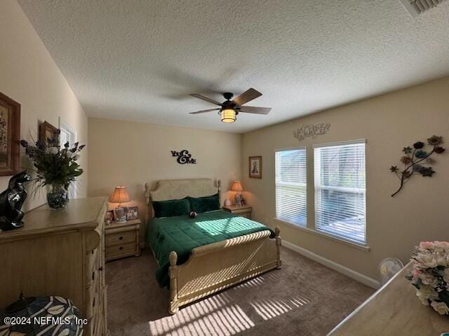 bedroom with dark carpet, a textured ceiling, and ceiling fan