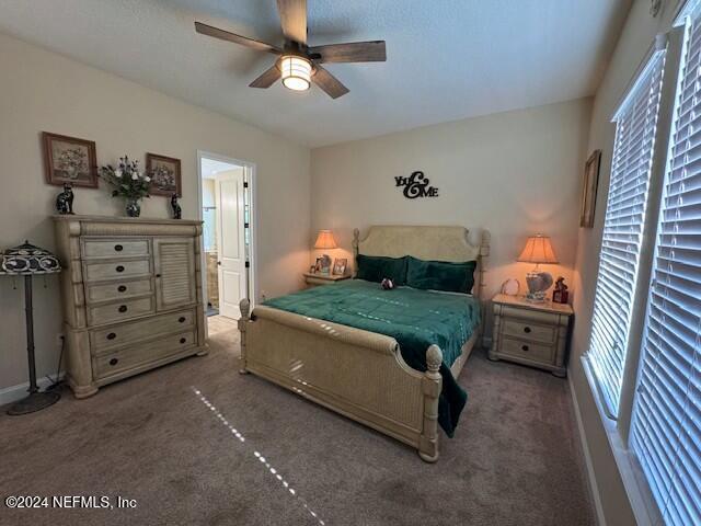 carpeted bedroom with ceiling fan