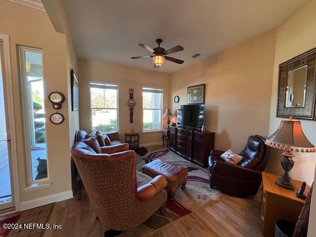 living room featuring ceiling fan and wood-type flooring