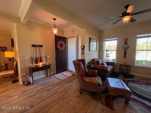 interior space with ceiling fan, crown molding, and wood-type flooring