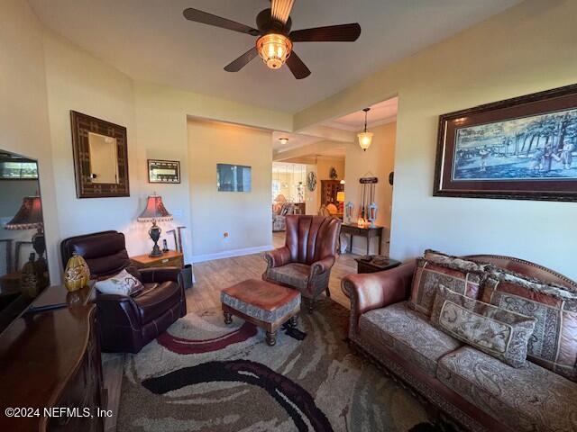 living room featuring ceiling fan and wood-type flooring