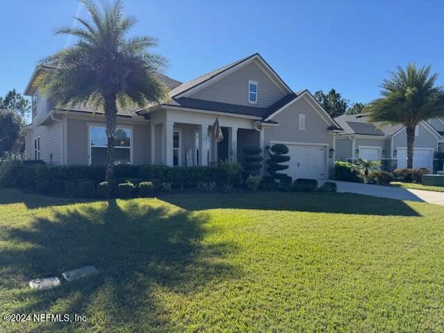 view of front of house featuring a garage and a front lawn