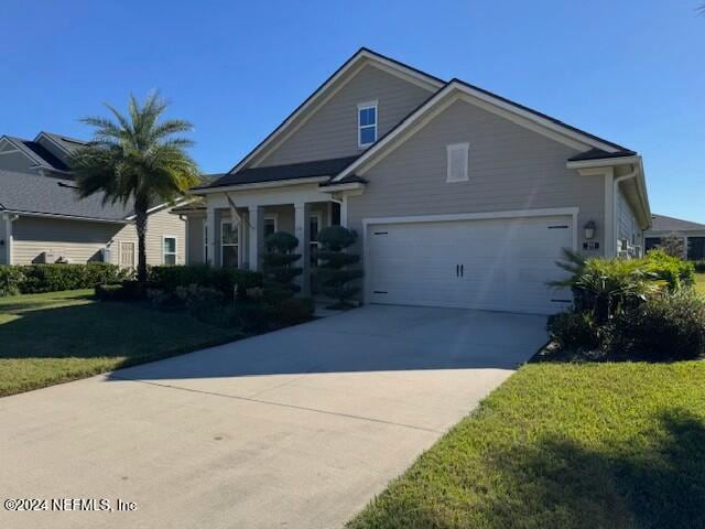 view of front facade with a garage and a front yard