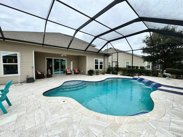 view of pool with glass enclosure, a patio area, and pool water feature