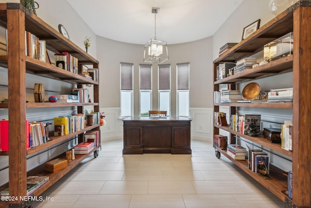 office area with light tile patterned flooring and an inviting chandelier