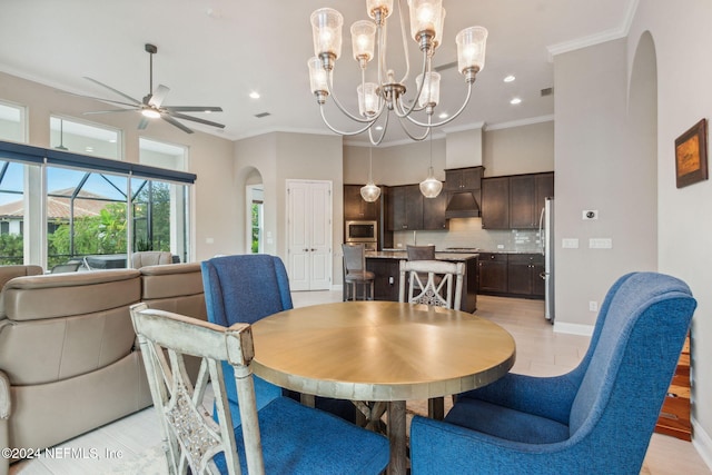 dining room with ceiling fan with notable chandelier and ornamental molding