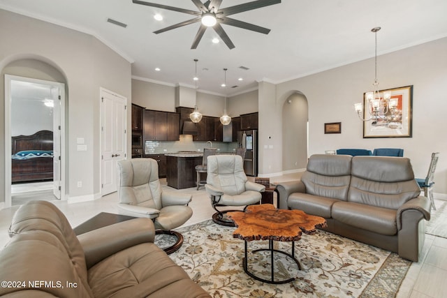 tiled living room featuring ornamental molding and ceiling fan with notable chandelier