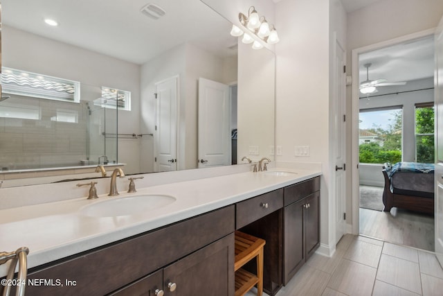 bathroom featuring vanity, hardwood / wood-style flooring, ceiling fan, and a shower with shower door