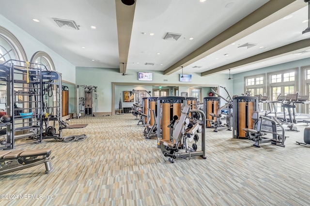 workout area featuring light colored carpet