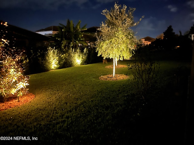 view of yard at twilight