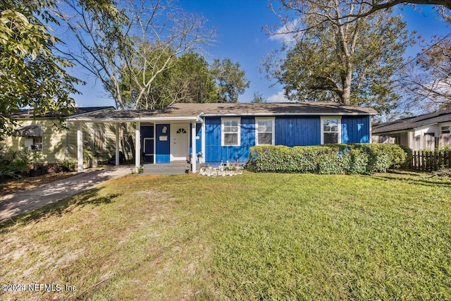 ranch-style home featuring a front yard and a carport