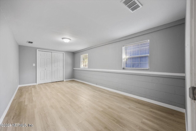 unfurnished bedroom featuring a closet and light hardwood / wood-style floors