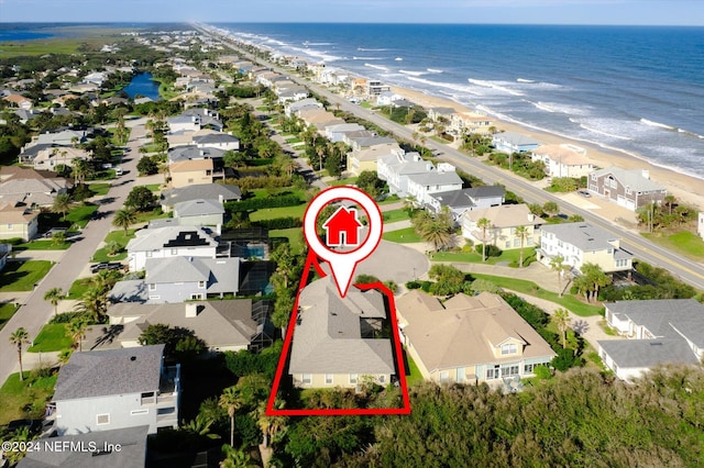 aerial view featuring a view of the beach and a water view