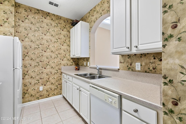 7801 Point Meadows Dr Unit 8406, Jacksonville, FL 32256 - kitchen featuring wallpapered walls, baseboards, light tile patterned floors, white appliances, and a sink