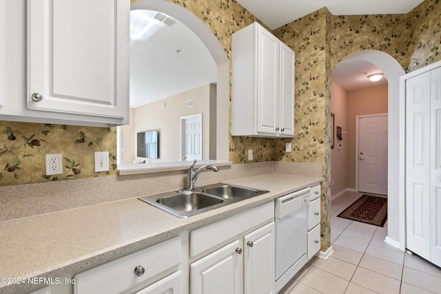 7801 Point Meadows Dr Unit 8406, Jacksonville, FL 32256 - kitchen featuring light tile patterned floors, a sink, wallpapered walls, arched walkways, and white dishwasher