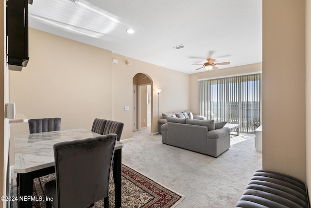 7801 Point Meadows Dr Unit 8406, Jacksonville, FL 32256 - living room featuring arched walkways, visible vents, ceiling fan, and light colored carpet
