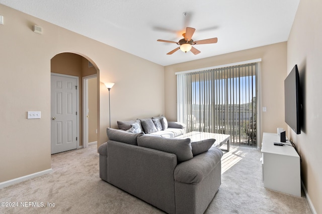 7801 Point Meadows Dr Unit 8406, Jacksonville, FL 32256 - living room with light carpet, arched walkways, a ceiling fan, and baseboards