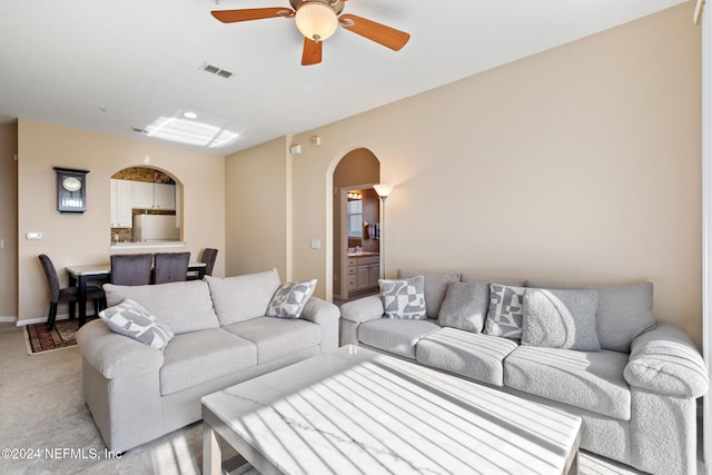 7801 Point Meadows Dr Unit 8406, Jacksonville, FL 32256 - living room featuring visible vents, baseboards, ceiling fan, arched walkways, and light colored carpet
