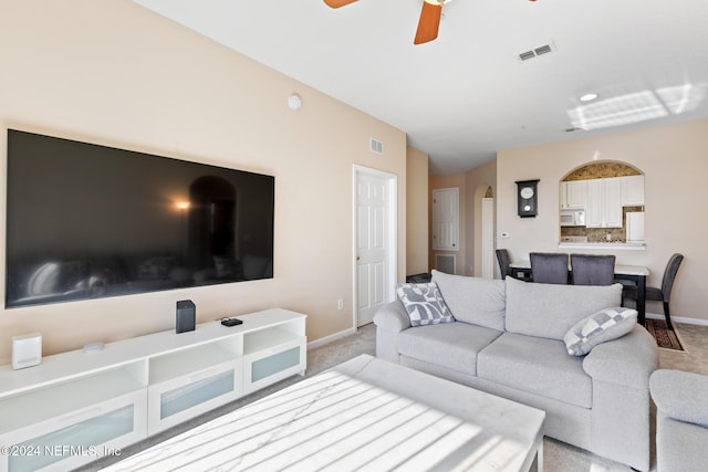 7801 Point Meadows Dr Unit 8406, Jacksonville, FL 32256 - living room with arched walkways, baseboards, visible vents, and light colored carpet