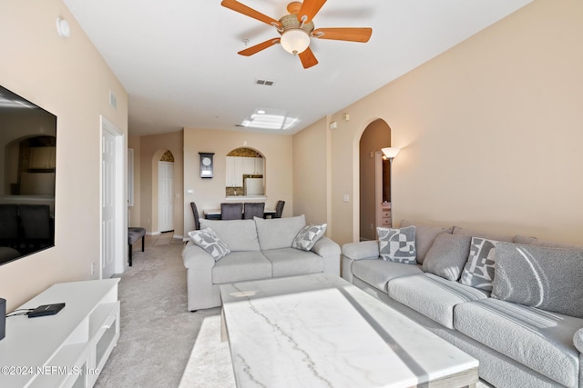 7801 Point Meadows Dr Unit 8406, Jacksonville, FL 32256 - living area featuring arched walkways, light carpet, visible vents, and ceiling fan