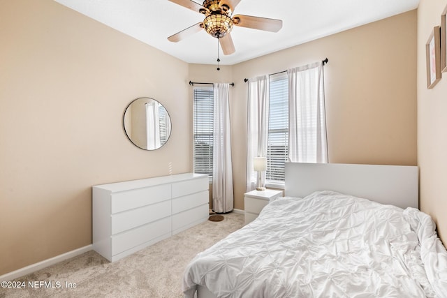 7801 Point Meadows Dr Unit 8406, Jacksonville, FL 32256 - bedroom with baseboards, ceiling fan, and light colored carpet