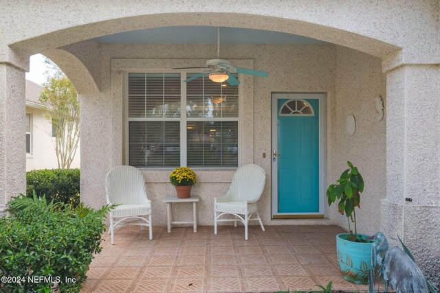 entrance to property featuring ceiling fan