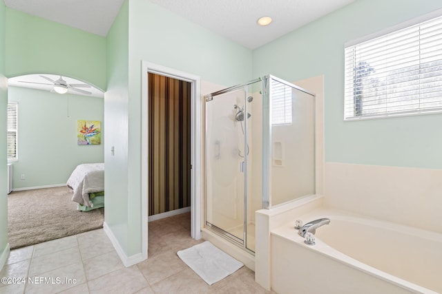 193 Lions Gate Dr, Saint Augustine, FL 32080 - ensuite bathroom featuring a shower stall, a garden tub, a ceiling fan, tile patterned flooring, and baseboards
