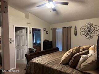 bedroom featuring ceiling fan, carpet, and vaulted ceiling