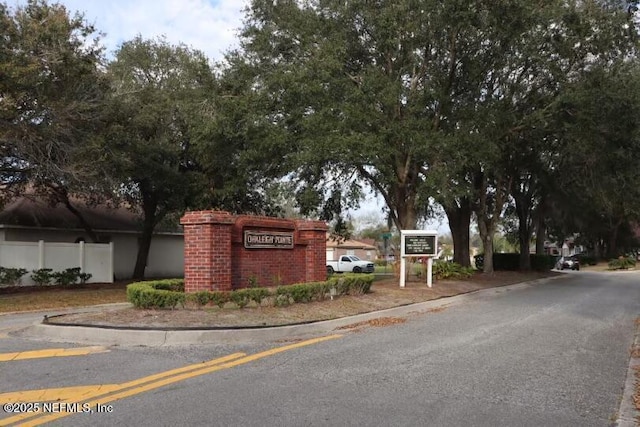 community sign featuring fence