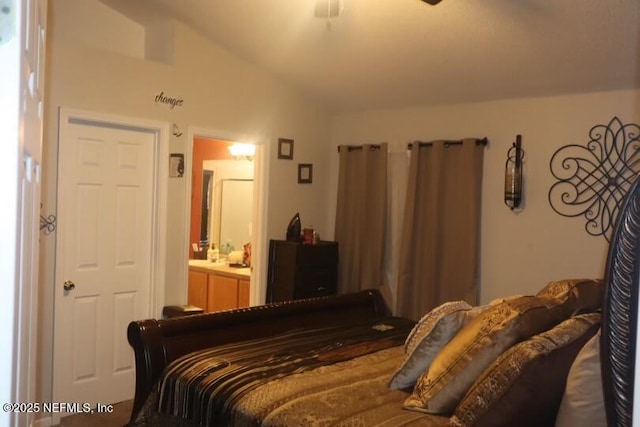 bedroom featuring lofted ceiling and ensuite bathroom