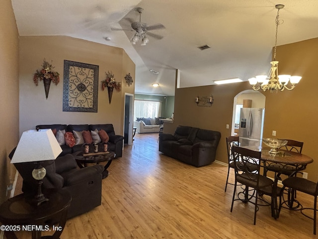 694 Cherry Bark Dr N, Jacksonville, FL 32218 - living room with arched walkways, ceiling fan with notable chandelier, light wood-type flooring, and visible vents