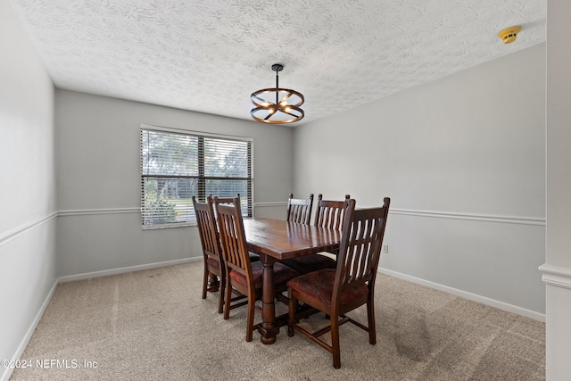 carpeted dining room with a textured ceiling and a notable chandelier