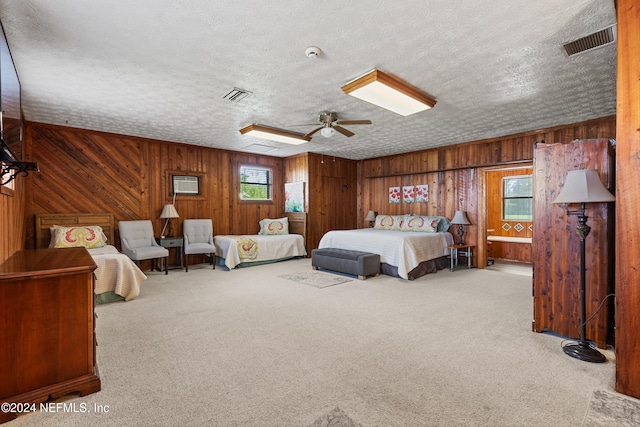 bedroom with ceiling fan, a textured ceiling, and carpet floors