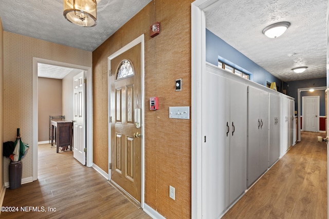 corridor featuring hardwood / wood-style floors and a textured ceiling