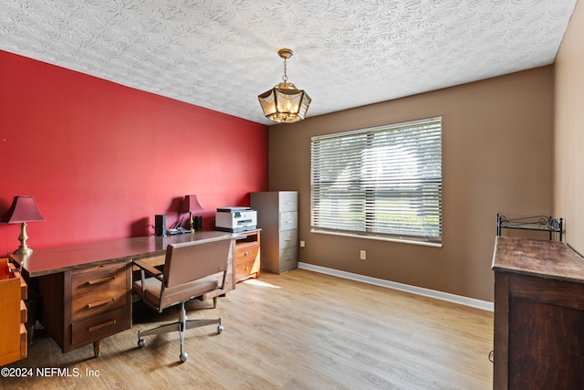 office with a textured ceiling, a notable chandelier, and light hardwood / wood-style flooring