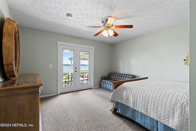 bedroom with access to exterior, french doors, a textured ceiling, and ceiling fan