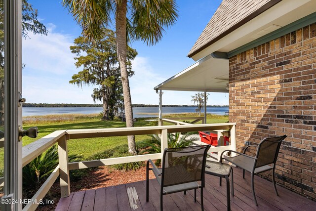 wooden deck with a water view