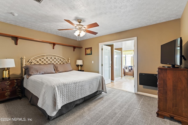 carpeted bedroom with a textured ceiling and ceiling fan