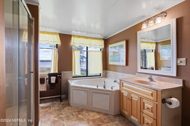 bathroom with independent shower and bath, vanity, and ornamental molding