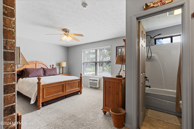 carpeted bedroom featuring a textured ceiling, ceiling fan, and a wall mounted air conditioner