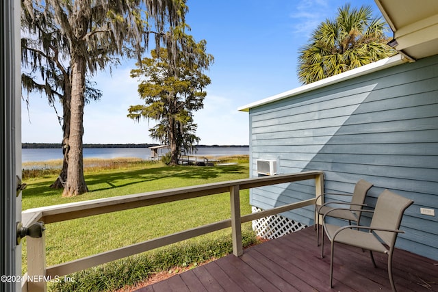 deck featuring a water view and a lawn