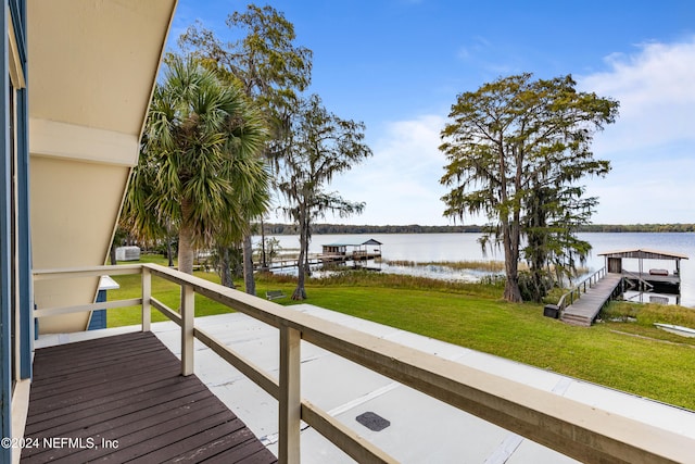 balcony featuring a water view and a boat dock