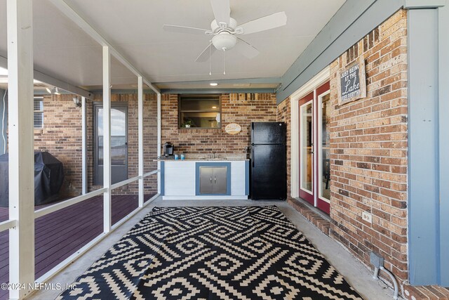 interior space with ceiling fan and sink